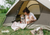 Girl camping with her dog, feeding freeze-dried raw dog food from dr. marty pets